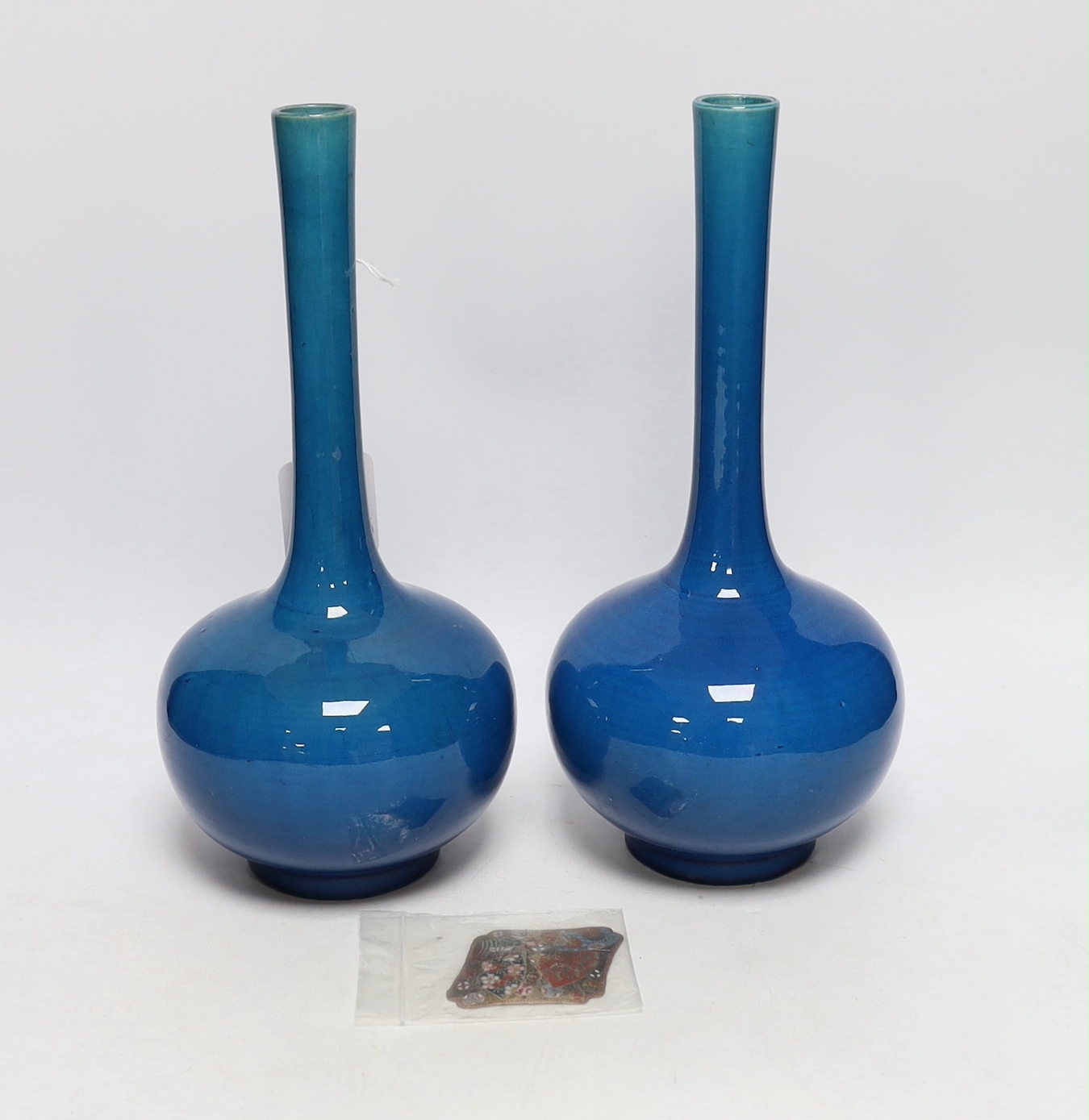 A pair of Japanese or Chinese blue monochrome bottle vases, c.1900 and a Japanese cloisonné enamel plaque